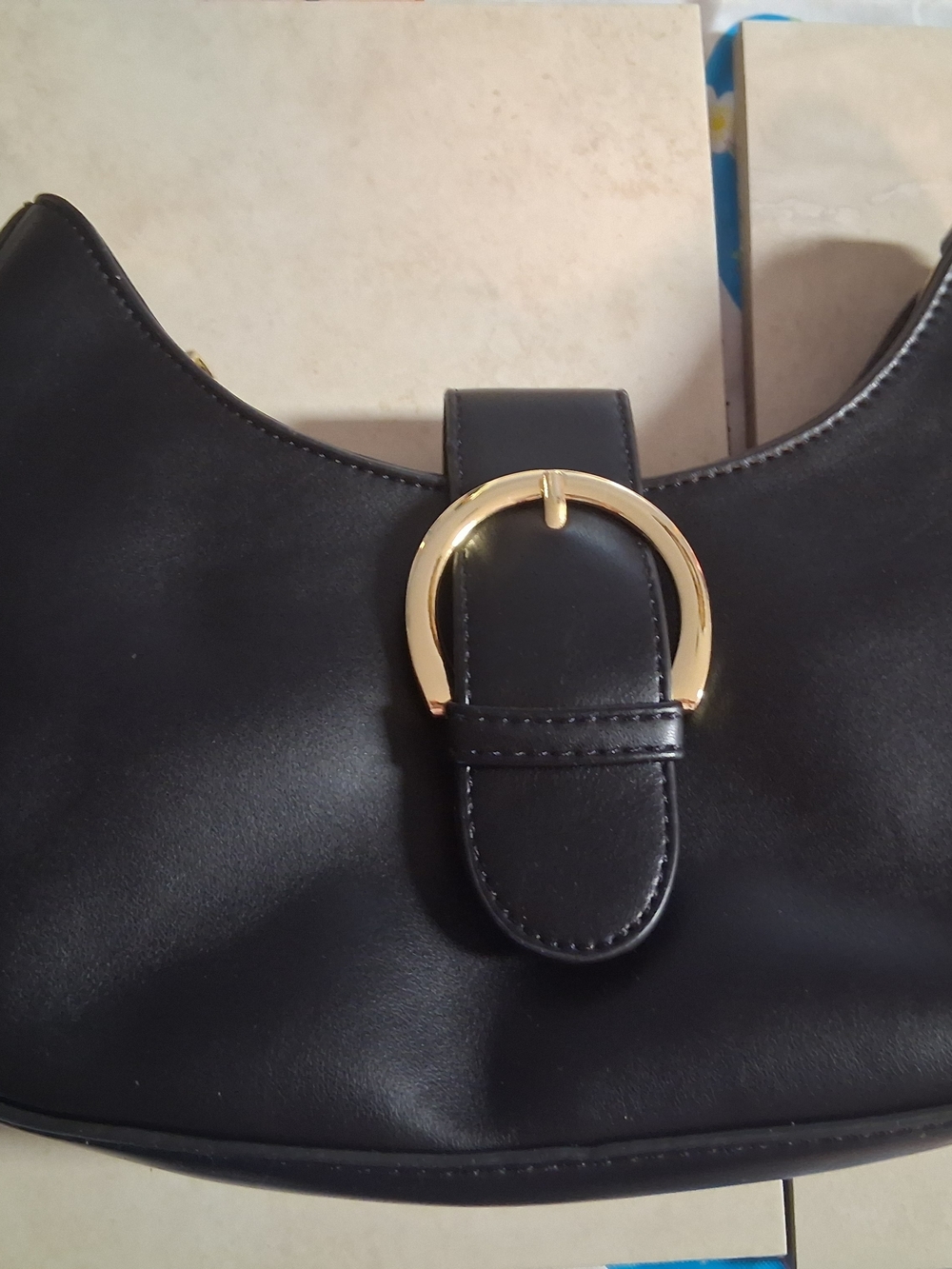 Sleek Black Shoulder Bag with Gold Buckle Accent